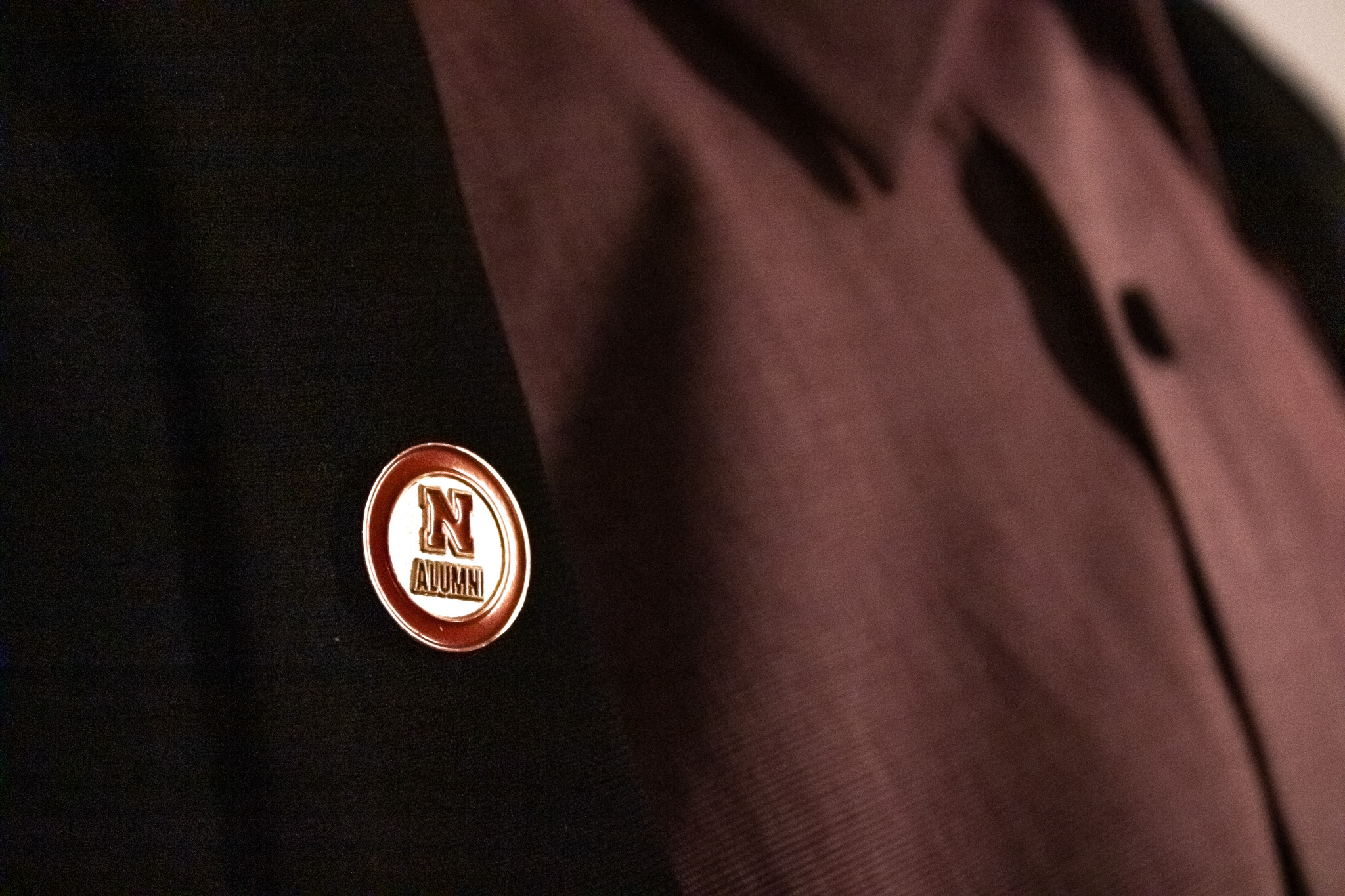 Nebraska alumni pin on a suit jacket