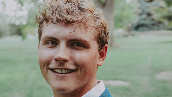 Smiling white male student wearing blazer