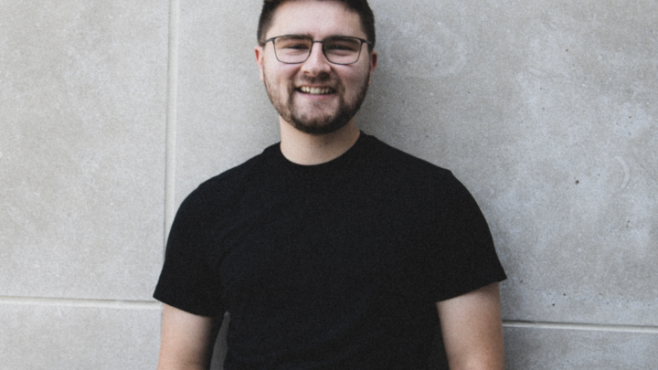 Alec Gettert smiles in headshot.