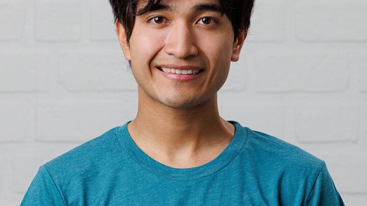 Roel Navarrete smiling in headshot.