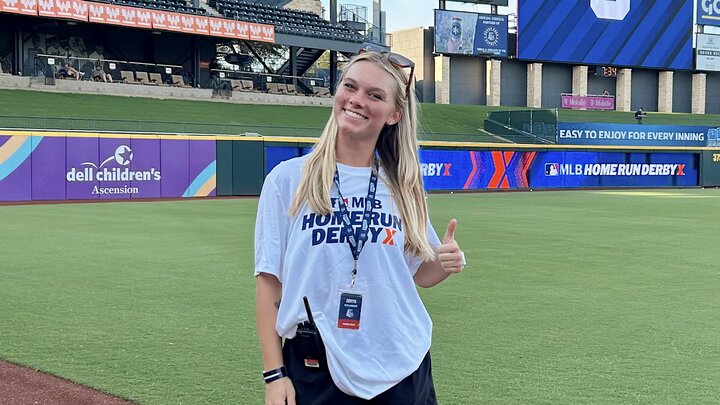 Gavyn smiling for a picture in a baseball field