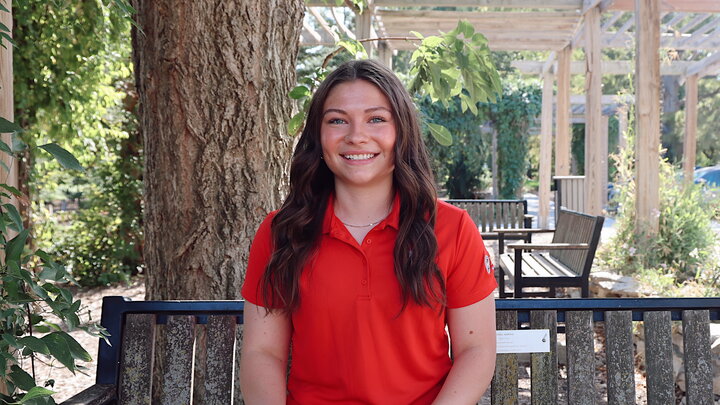 Julie smiling for a picture outside.