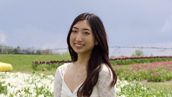 Julie smiling in a flower field