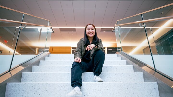 Kiley Pham smiling on Kiewit stairs.