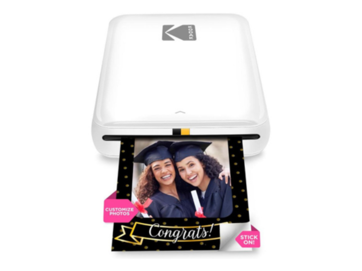 Kodak mini photo printer with picture of 2 female graduates coming out of it