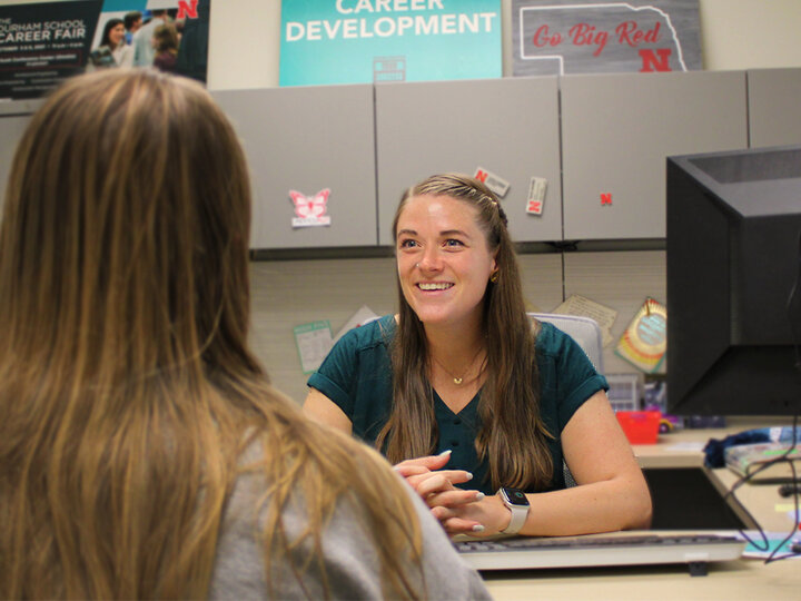 Career coach talking to engineering student.