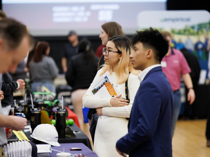 Students talking to employer at career fair